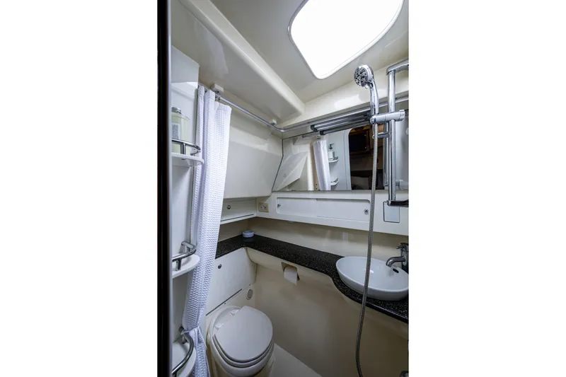 5 O' Clock Somewhere Yacht Photos Pics Compact bathroom in 2010 Scout 350 Abaco boat with shower, sink, and toilet.