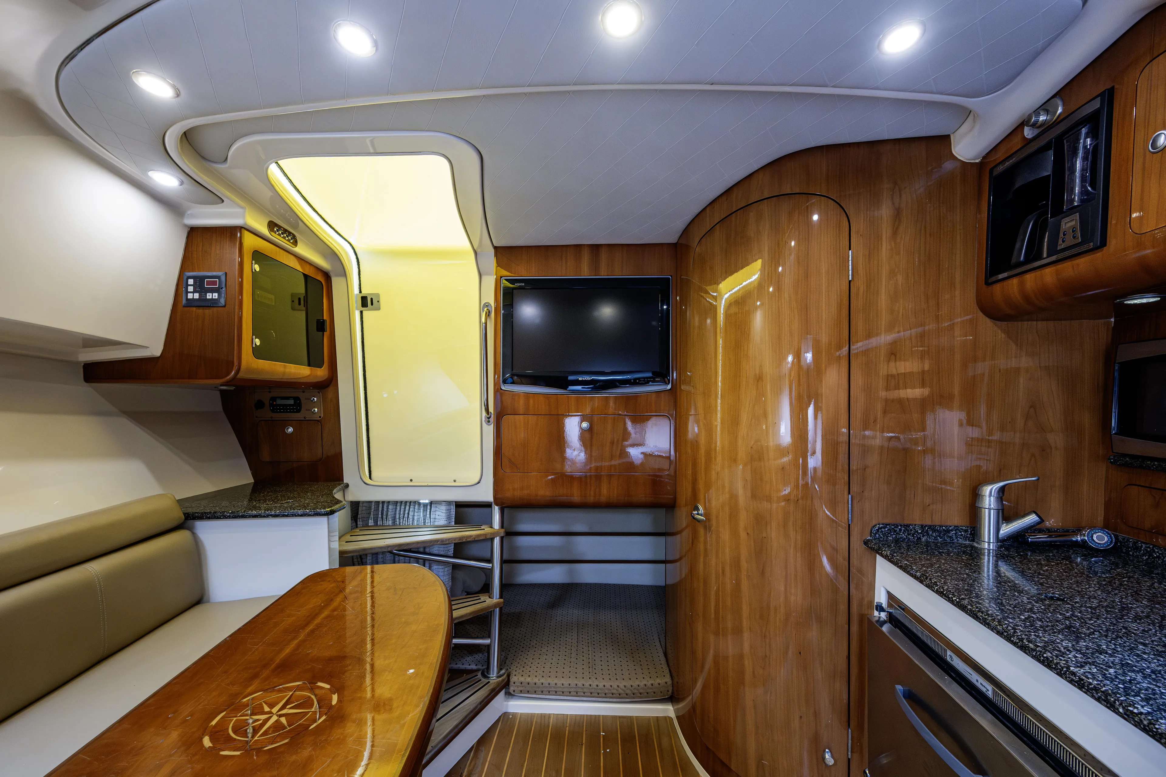 5 O' Clock Somewhere Yacht Photos Pics Luxurious interior of 2010 Scout 350 Abaco boat with wood finish and modern amenities.