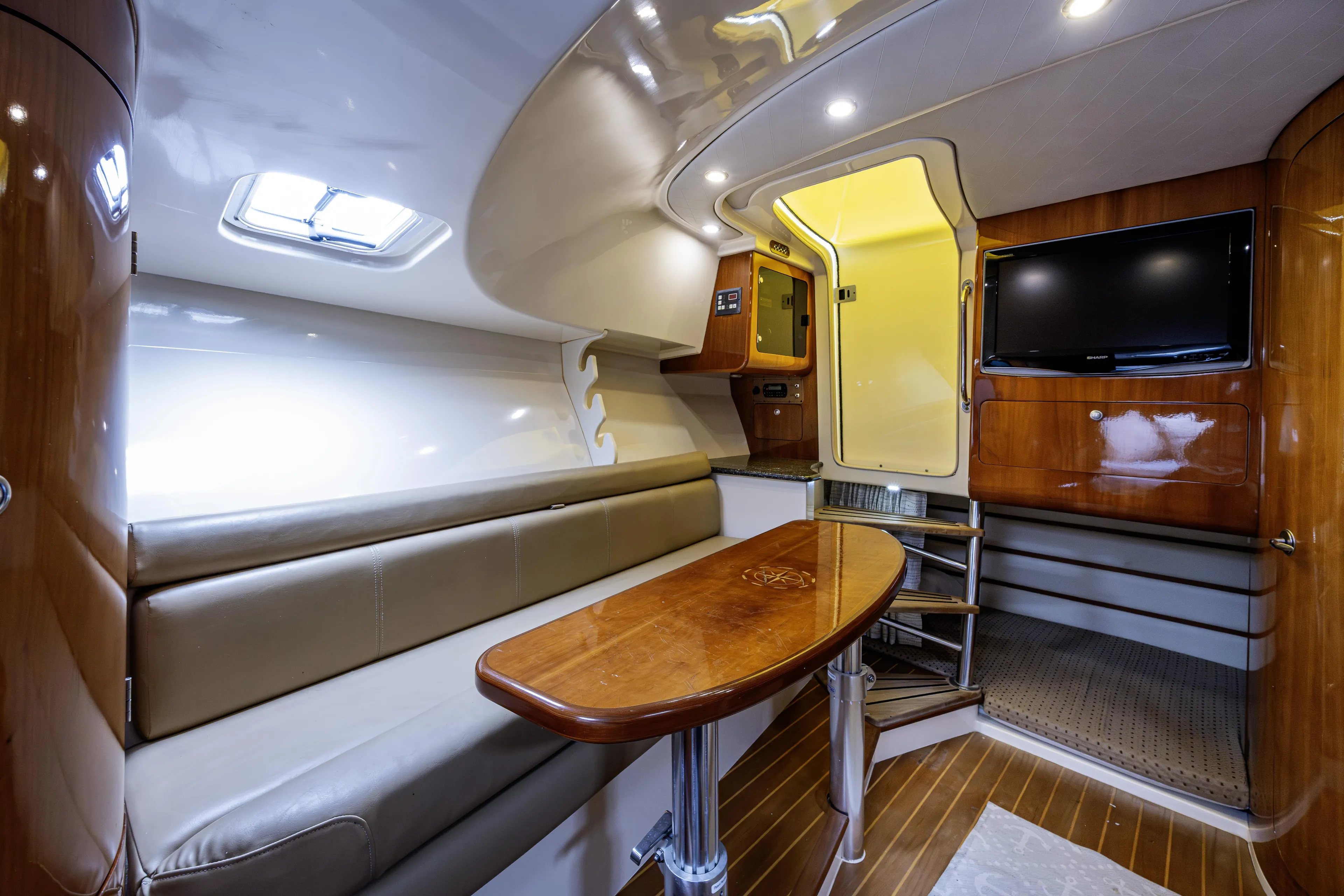 5 O' Clock Somewhere Yacht Photos Pics Luxurious interior of 2010 Scout 350 Abaco boat with seating, table, and TV.