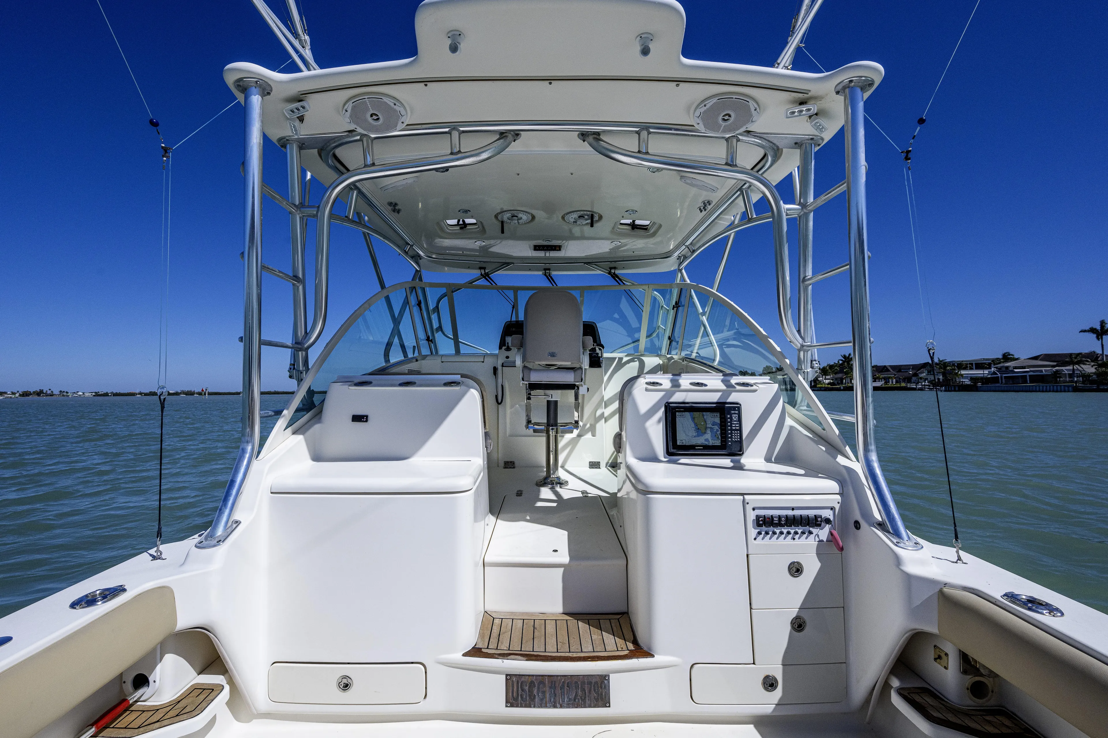 5 O' Clock Somewhere Yacht Photos Pics 2010 Scout 350 Abaco boat interior with navigation system, on calm water under clear blue sky.