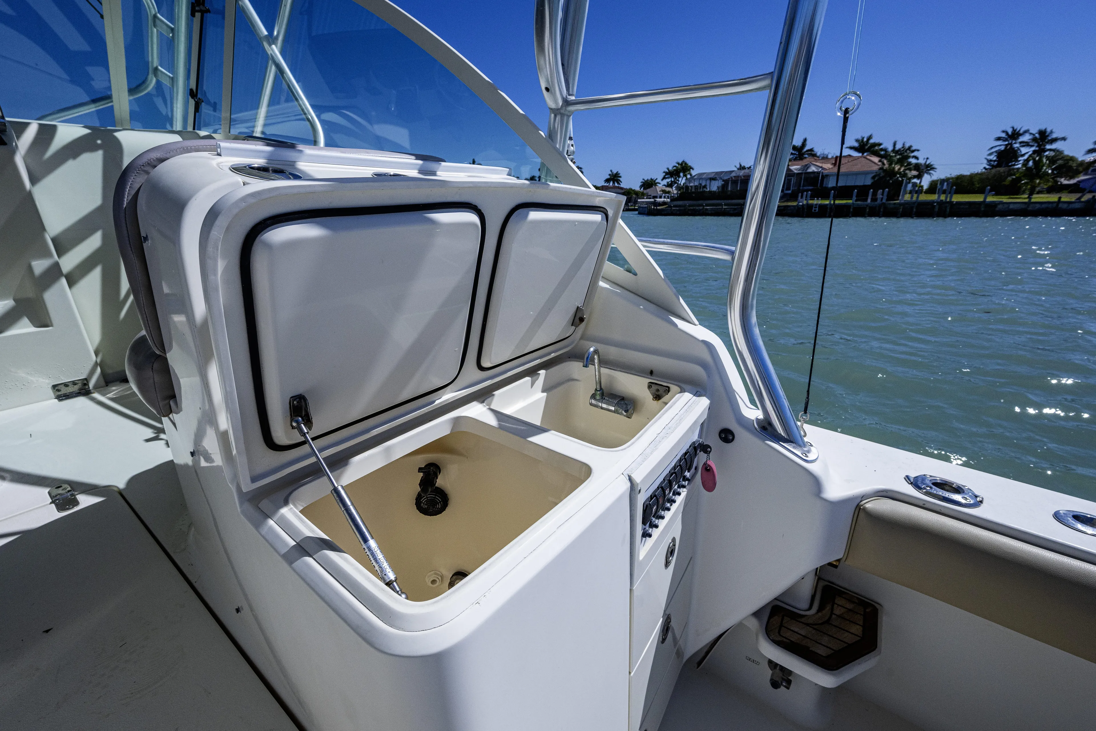 5 O' Clock Somewhere Yacht Photos Pics 2010 Scout 350 Abaco boat interior with open storage compartments and sink.