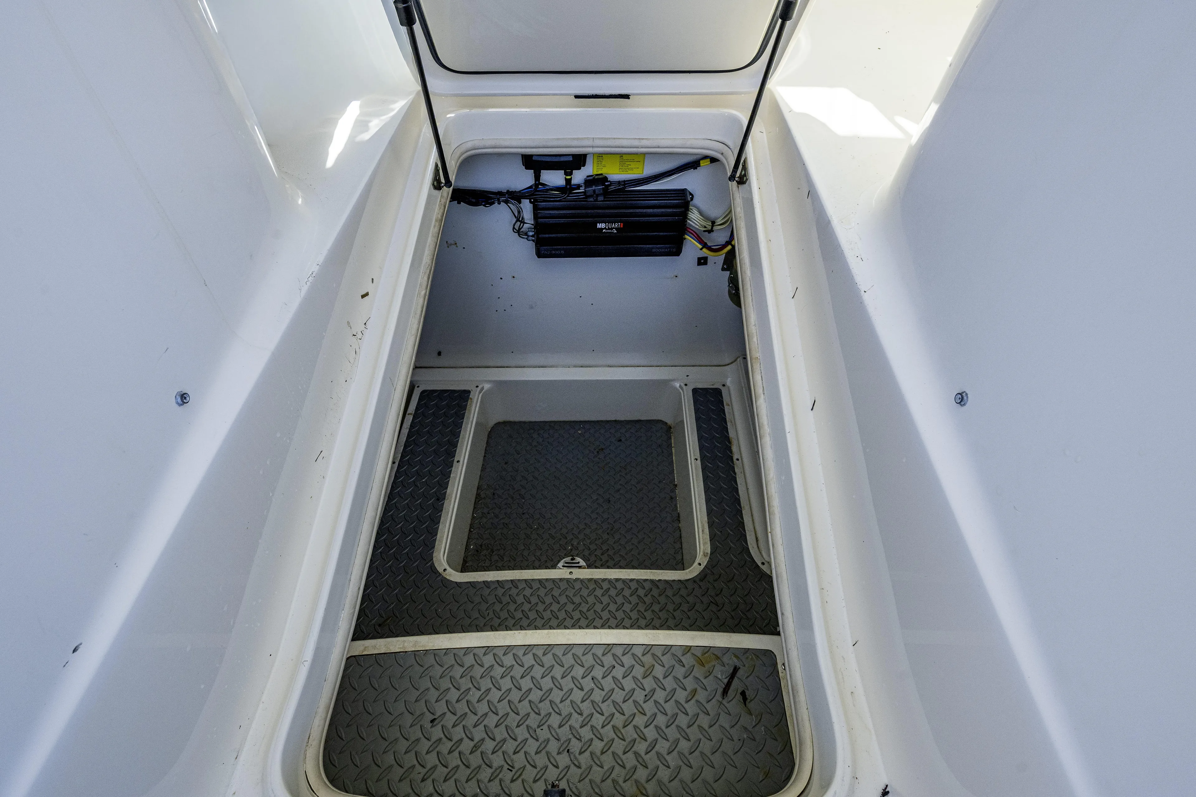 5 O' Clock Somewhere Yacht Photos Pics Open storage compartment in 2010 Scout 350 Abaco boat, featuring diamond-patterned flooring.
