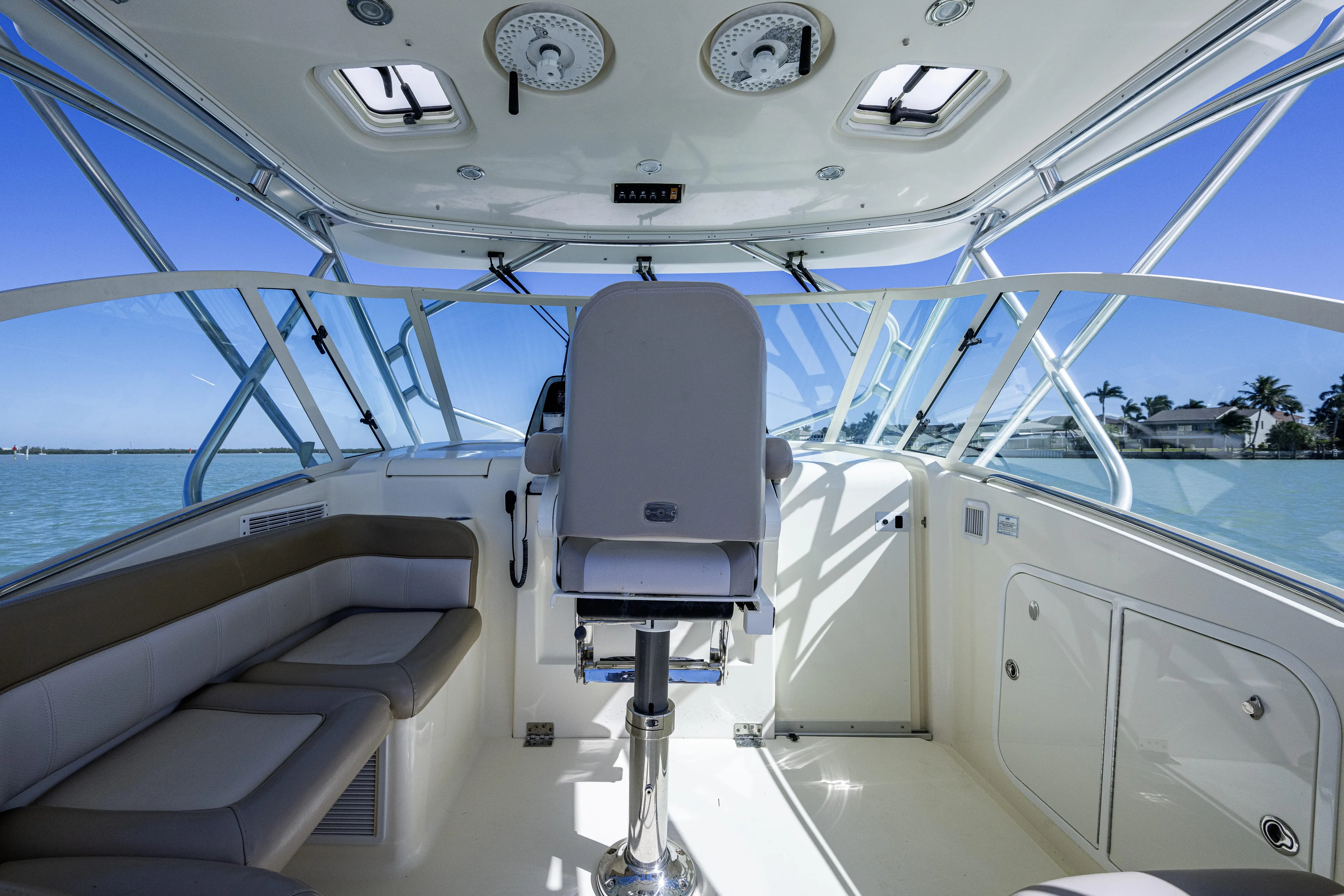 5 O' Clock Somewhere Yacht Photos Pics Interior view of 2010 Scout 350 Abaco boat with seating and helm.