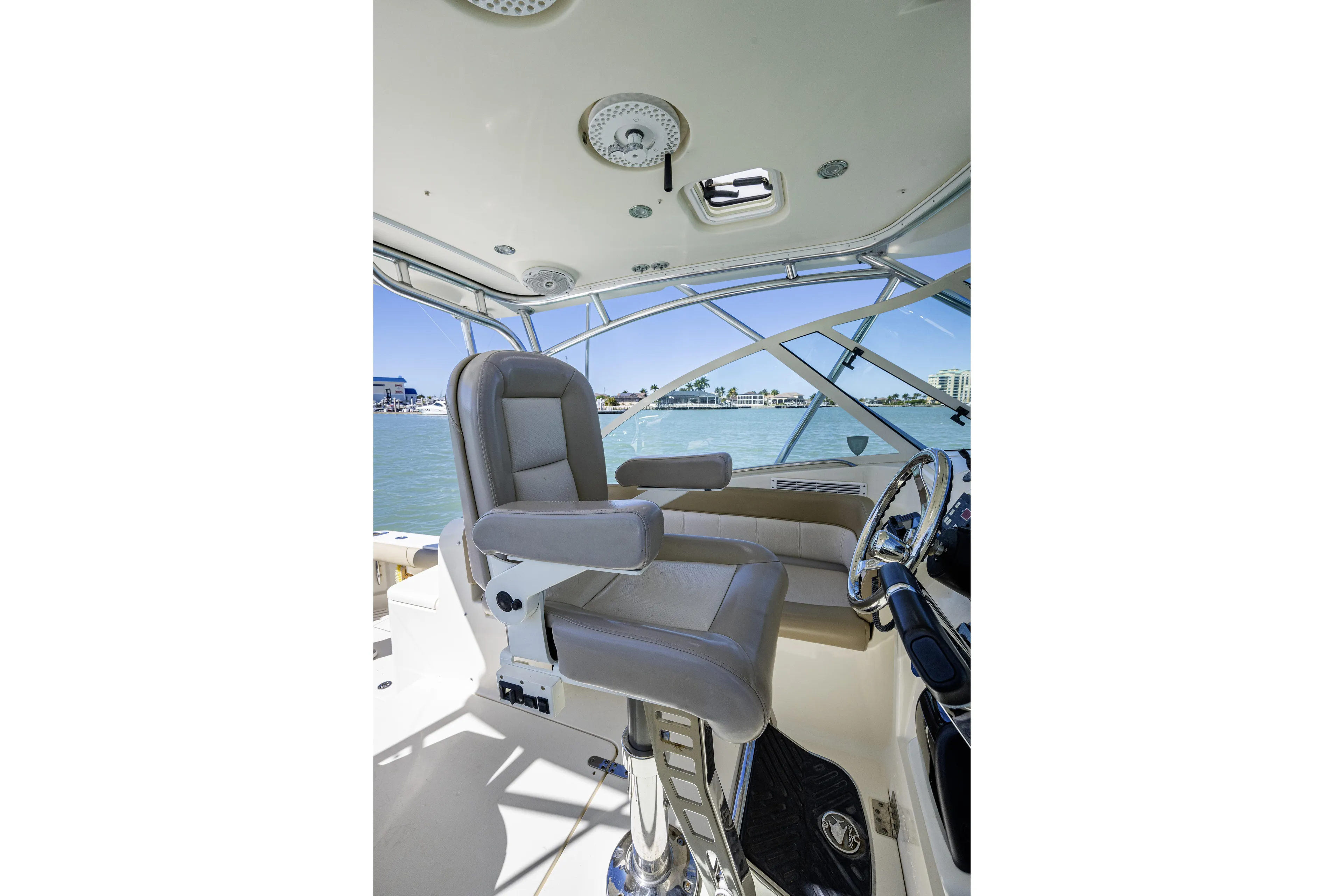 5 O' Clock Somewhere Yacht Photos Pics Captain's chair and helm of 2010 Scout 350 Abaco boat, overlooking marina.