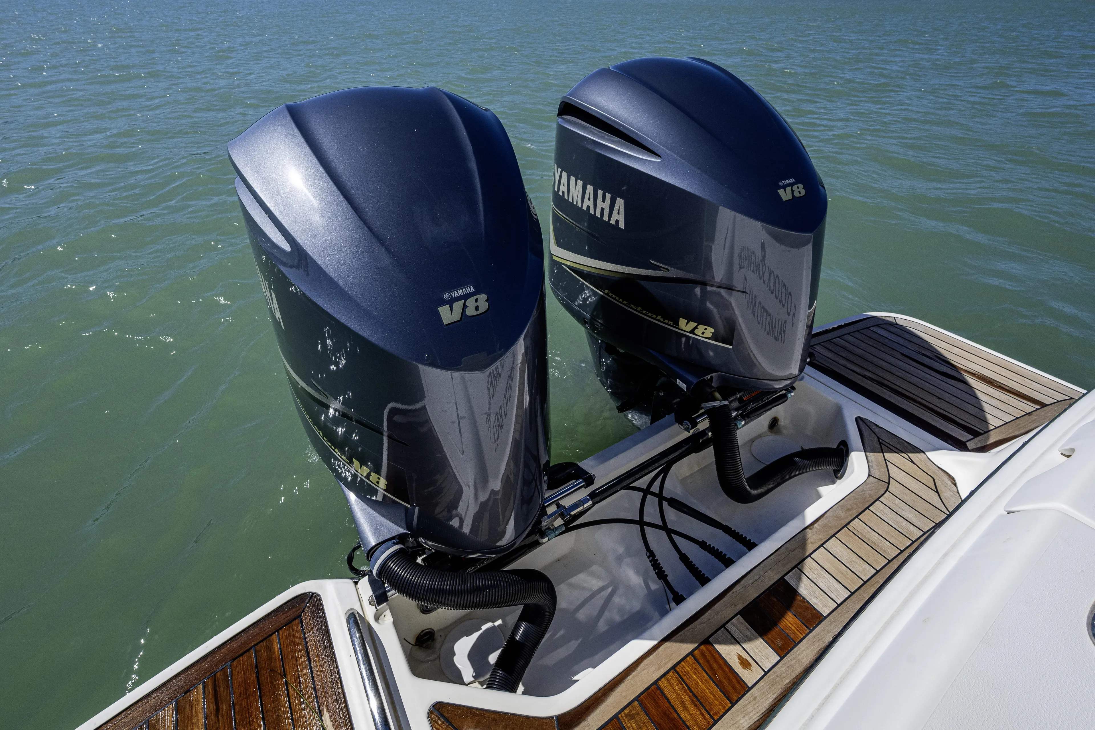 5 O' Clock Somewhere Yacht Photos Pics Twin Yamaha V8 engines on a 2010 Scout 350 Abaco boat, docked on water.