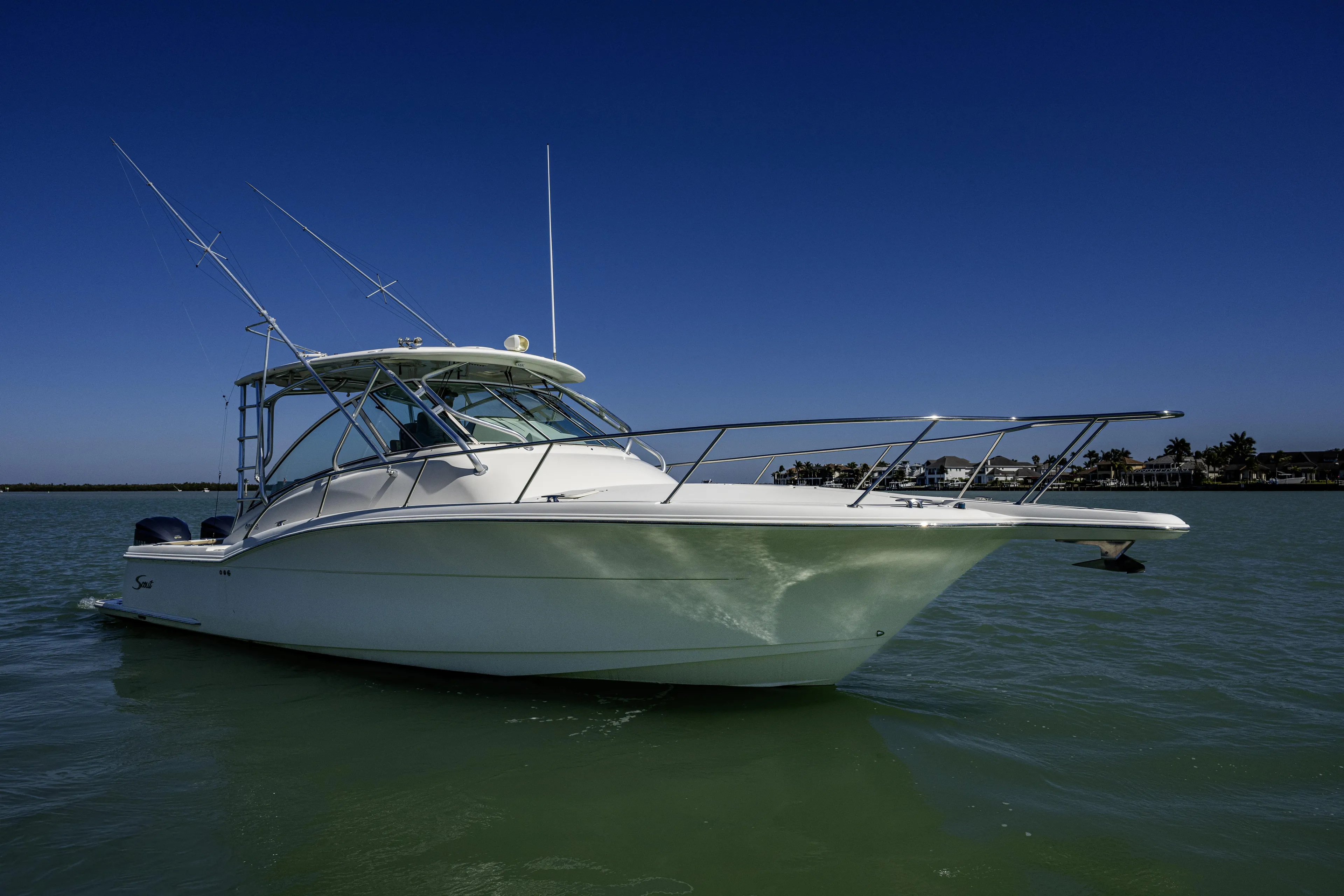 5 O' Clock Somewhere Yacht Photos Pics 2010 Scout 350 Abaco boat on calm water under clear blue sky.