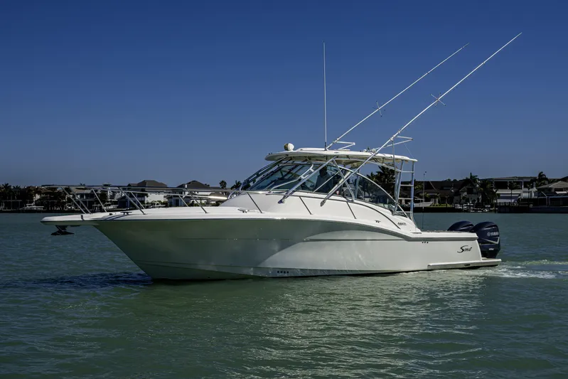 5 O' Clock Somewhere Yacht Photos Pics 2010 Scout 350 Abaco boat cruising on calm water under clear blue sky.