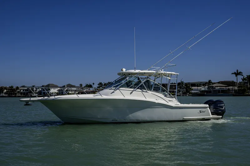 5 O' Clock Somewhere Yacht Photos Pics 2010 Scout 350 Abaco boat cruising on calm waters under clear blue sky.