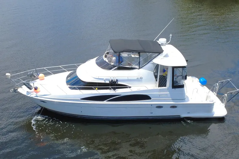 IV Play Too Yacht Photos Pics 2005 Carver 444 Cockpit Motor Yacht on calm water, side view.