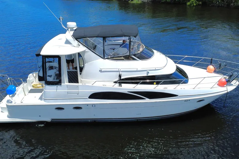 IV Play Too Yacht Photos Pics 2005 Carver 444 Cockpit Motor Yacht on calm water, featuring sleek design and spacious deck.