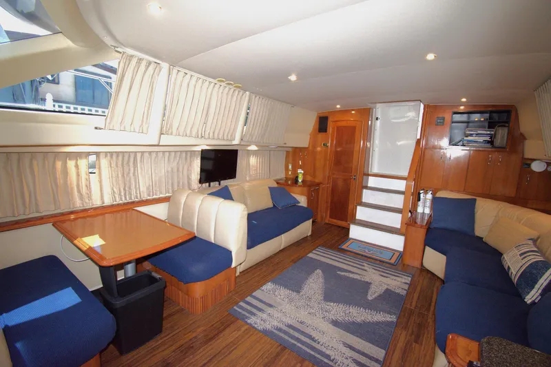 IV Play Too Yacht Photos Pics Luxurious interior of 2005 Carver 444 Cockpit Motor Yacht with elegant seating and wooden finishes.