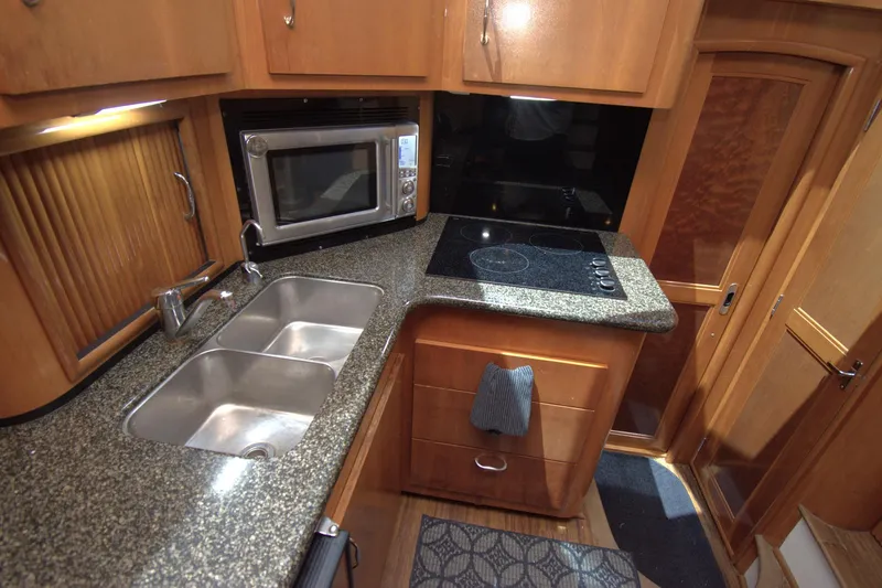 IV Play Too Yacht Photos Pics 2005 Carver 444 Cockpit Motor Yacht kitchen with granite countertops and modern appliances.