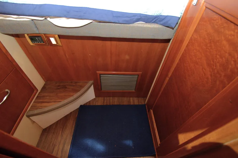 IV Play Too Yacht Photos Pics Interior of 2005 Carver 444 Cockpit Motor Yacht with wooden paneling and blue carpet.