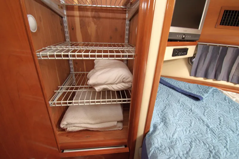 IV Play Too Yacht Photos Pics Interior of 2005 Carver 444 Cockpit Motor Yacht with bedding and storage shelves.