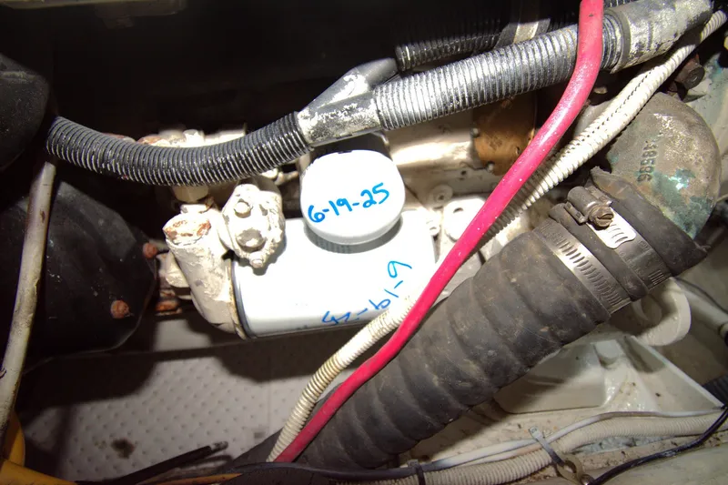 IV Play Too Yacht Photos Pics Engine compartment of a 2005 Carver 444 Cockpit Motor Yacht with visible hoses and wiring.