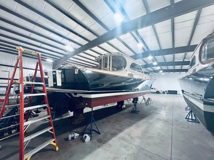 Mallard Yacht Photos Pics 2005 Hinckley Talaria 44 MY yacht in a storage facility with a ladder nearby.