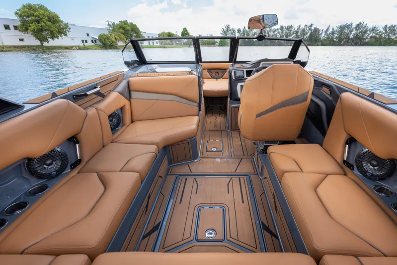 Yacht Photos Pics Luxurious interior of 2025 Centurion Nv233 boat with tan leather seating and modern design.