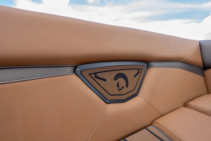  Yacht Photos Pics 2025 Centurion Nv233 boat interior with tan leather seating and stylish emblem.