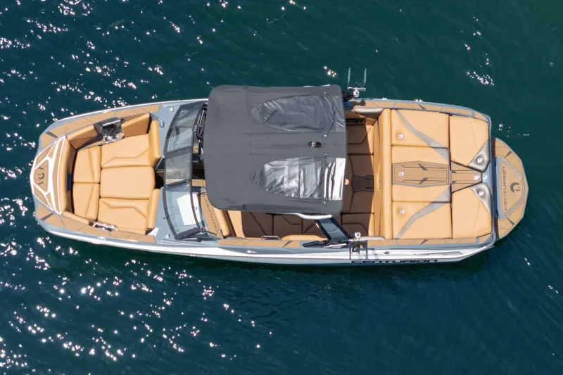  Yacht Photos Pics Aerial view of 2025 Centurion Nv233 boat with tan seating on blue water.