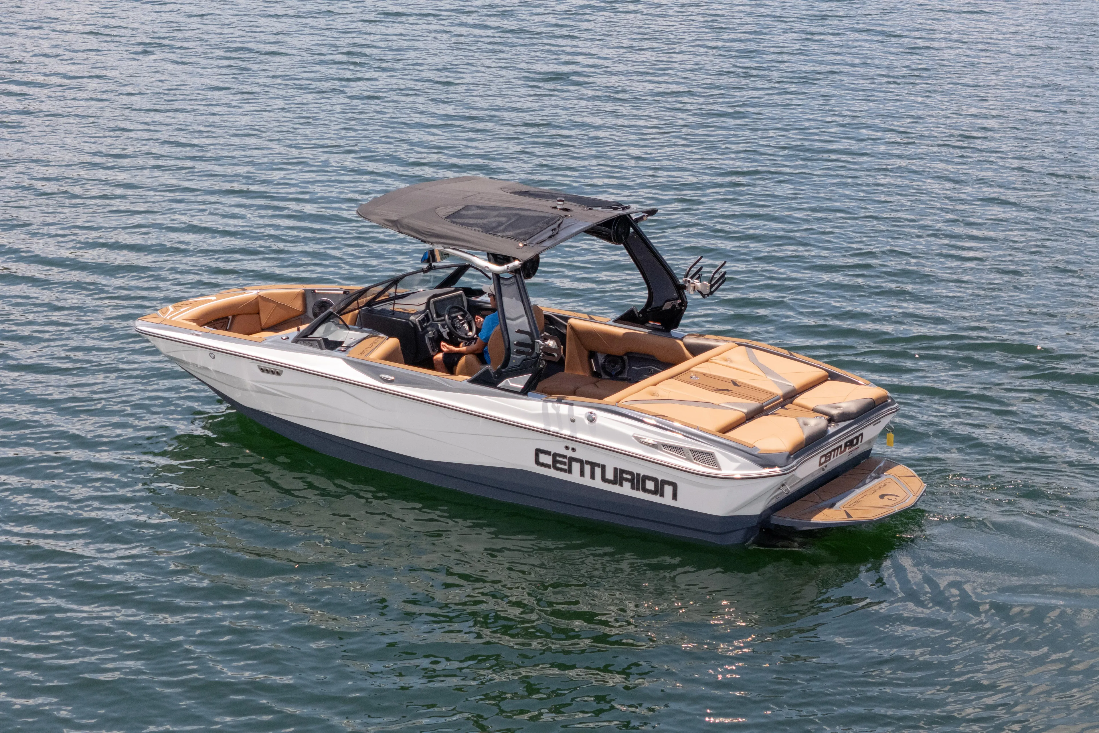  Yacht Photos Pics 2025 Centurion Nv233 boat on water, featuring sleek design and tan interior.