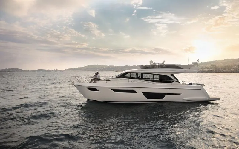  Yacht Photos Pics 2025 Ferretti Yachts 500 cruising on serene waters at sunset.