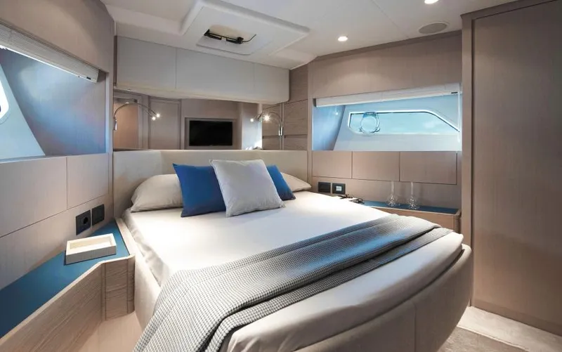  Yacht Photos Pics Luxurious bedroom interior of 2025 Ferretti Yachts 500, featuring modern design and elegant furnishings.