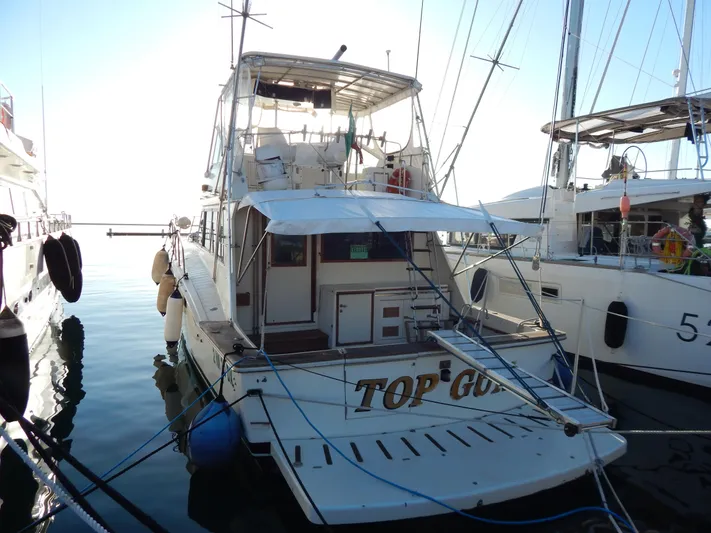  Yacht Photos Pics 1981 Hatteras 50 Convertible yacht docked at marina, rear view.