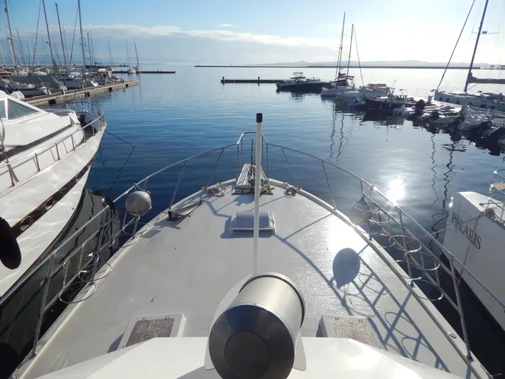  Yacht Photos Pics 1981 Hatteras 50 Convertible yacht docked in a serene marina setting.