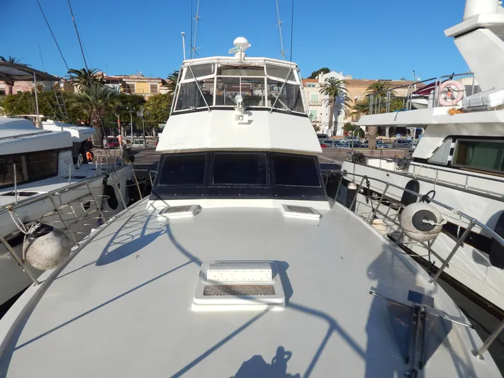  Yacht Photos Pics 1981 Hatteras 50 Convertible yacht docked in a marina, viewed from the bow.