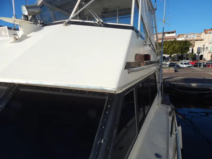  Yacht Photos Pics 1981 Hatteras 50 Convertible yacht docked at a marina, showcasing its sleek design.