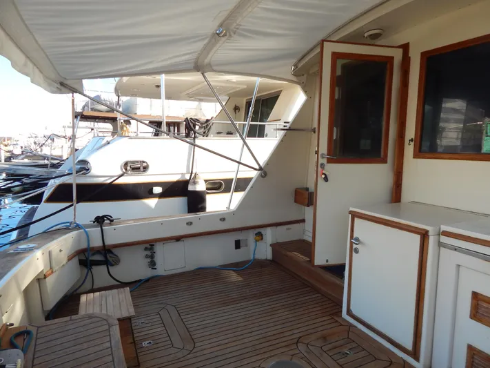  Yacht Photos Pics 1981 Hatteras 50 Convertible yacht deck with wooden flooring and canopy.