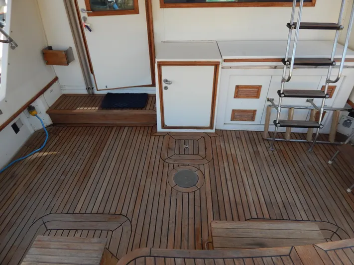  Yacht Photos Pics 1981 Hatteras 50 Convertible yacht deck with wooden flooring and storage compartments.