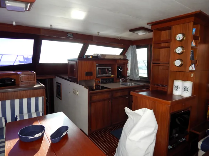  Yacht Photos Pics Interior of 1981 Hatteras 50 Convertible yacht with wood cabinetry and nautical decor.