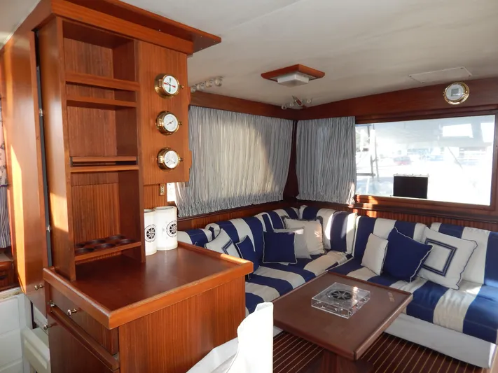 Yacht Photos Pics Interior of 1981 Hatteras 50 Convertible yacht with striped seating and wooden cabinetry.