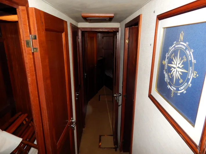  Yacht Photos Pics Hallway inside 1981 Hatteras 50 Convertible yacht with wooden doors and nautical decor.