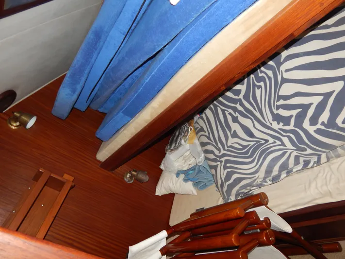  Yacht Photos Pics Interior cabin of 1981 Hatteras 50 Convertible with blue and zebra-patterned bedding.