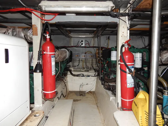  Yacht Photos Pics Engine room of 1981 Hatteras 50 Convertible with fire extinguishers and machinery.
