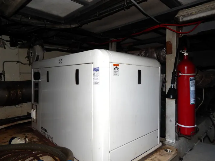  Yacht Photos Pics Engine room of 1981 Hatteras 50 Convertible with generator and fire extinguisher.