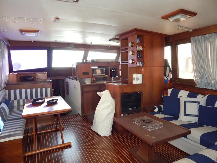  Yacht Photos Pics Interior of 1981 Hatteras 50 Convertible yacht with wood finish and striped seating.