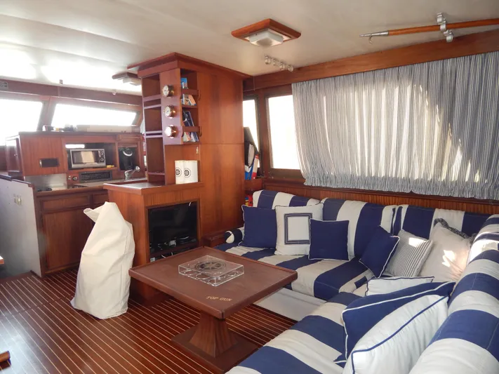  Yacht Photos Pics Interior of 1981 Hatteras 50 Convertible yacht with striped seating and wooden accents.