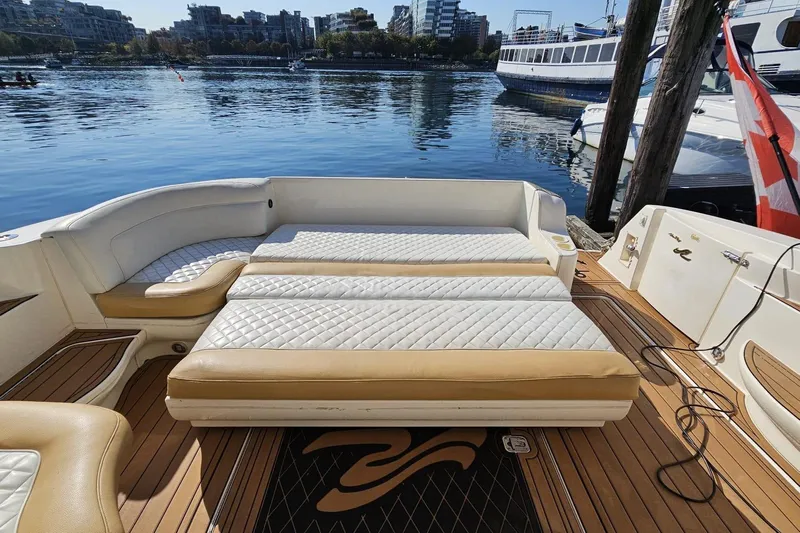  Yacht Photos Pics 1999 Sea Ray 460 Sundancer yacht with spacious deck and luxurious seating by the water.