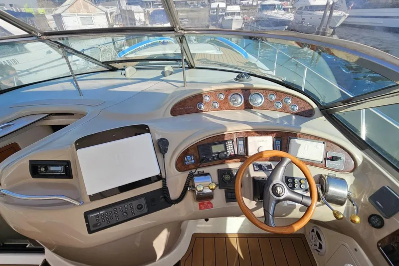  Yacht Photos Pics 1999 Sea Ray 460 Sundancer helm with wooden steering wheel and navigation instruments.