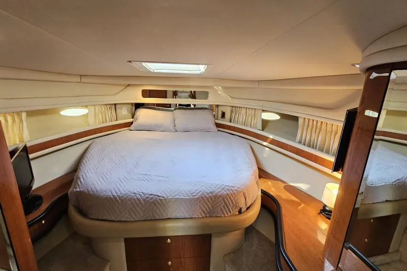  Yacht Photos Pics Luxurious cabin interior of 1999 Sea Ray 460 Sundancer yacht with cozy bed and elegant decor.