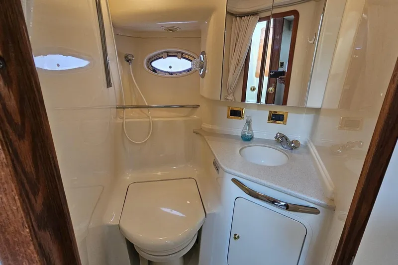  Yacht Photos Pics Bathroom interior of 1999 Sea Ray 460 Sundancer yacht, featuring shower and sink.