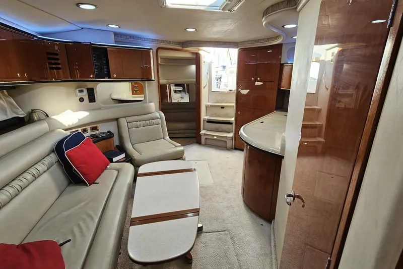  Yacht Photos Pics Luxurious interior of 1999 Sea Ray 460 Sundancer yacht with elegant seating and wood finishes.