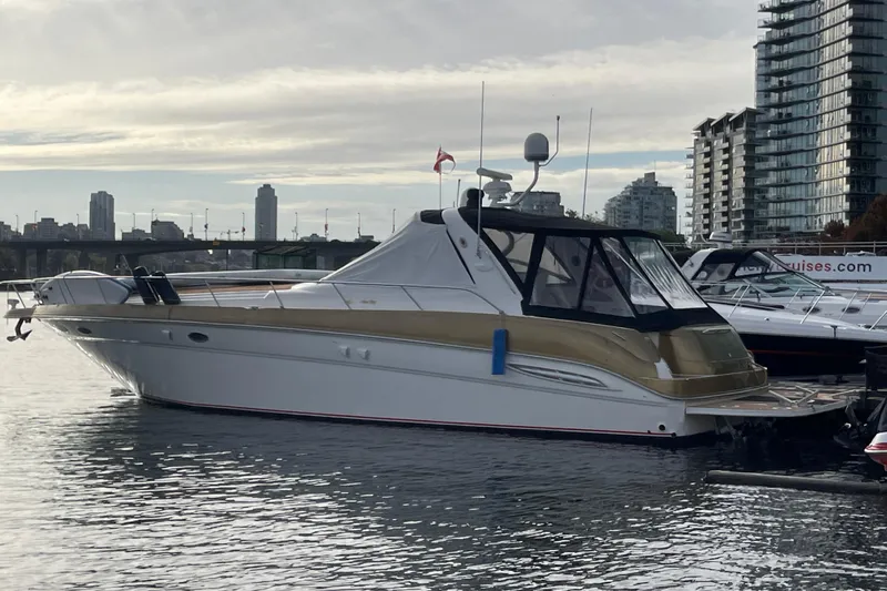  Yacht Photos Pics 1999 Sea Ray 460 Sundancer yacht docked in urban marina with city skyline.