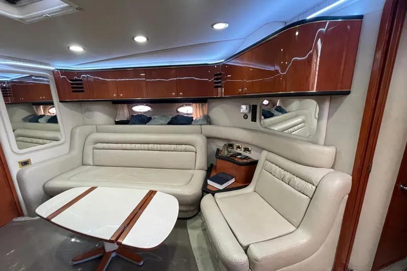  Yacht Photos Pics Luxurious interior of a 1999 Sea Ray 460 Sundancer yacht with plush seating and elegant wood finishes.