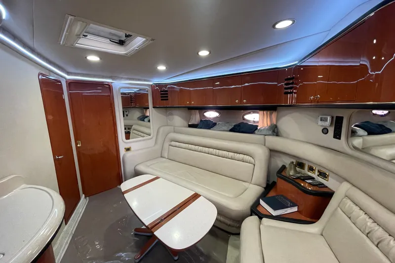  Yacht Photos Pics Luxurious interior of 1999 Sea Ray 460 Sundancer yacht with elegant seating and cabinetry.