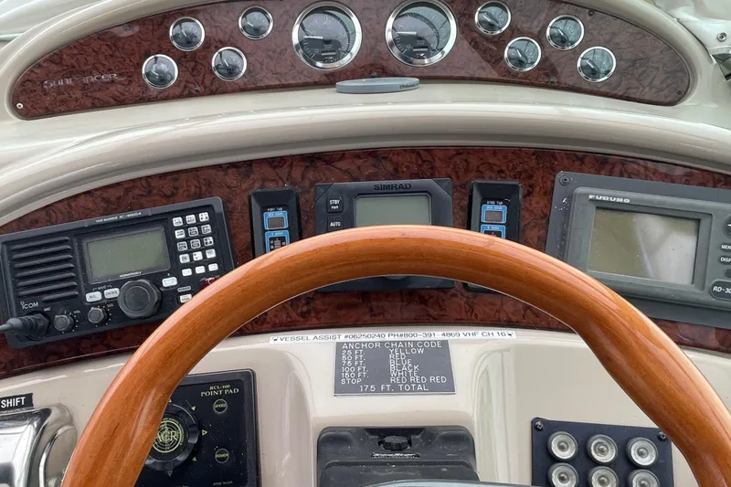  Yacht Photos Pics 1999 Sea Ray 460 Sundancer helm with wood steering wheel and navigation instruments.