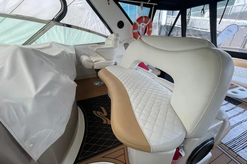  Yacht Photos Pics Interior of 1999 Sea Ray 460 Sundancer yacht with white leather seating and wooden flooring.
